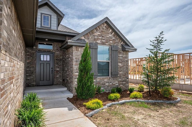 doorway to property with brick siding