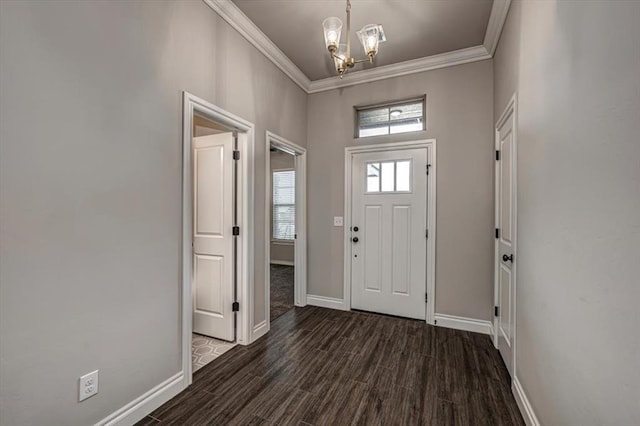 entryway with a chandelier, baseboards, plenty of natural light, and crown molding