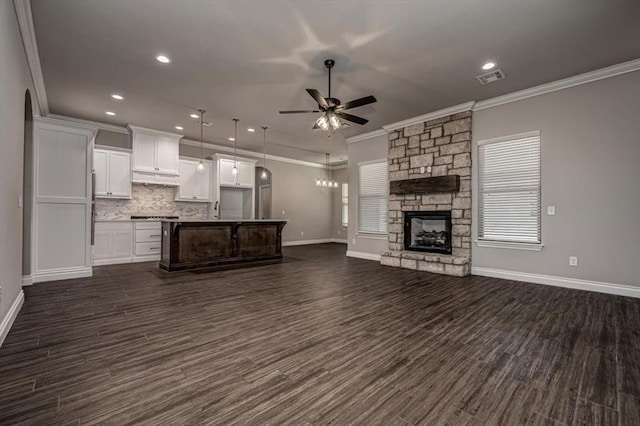 unfurnished living room featuring a ceiling fan, crown molding, baseboards, dark wood-style flooring, and recessed lighting