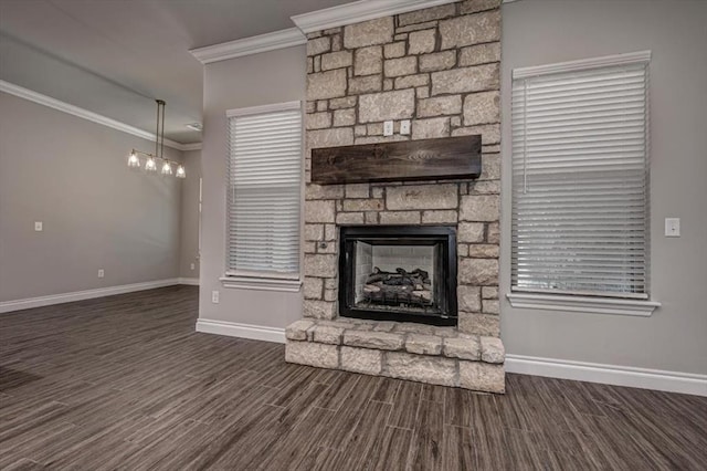 unfurnished living room featuring ornamental molding, wood finished floors, baseboards, and a stone fireplace