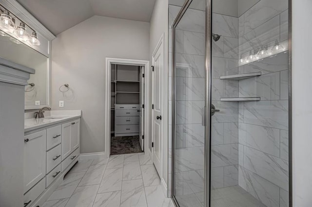 full bathroom featuring marble look tiles, a stall shower, vanity, vaulted ceiling, and a walk in closet