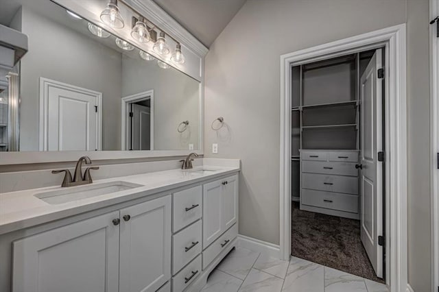 full bathroom featuring marble look tile flooring, double vanity, and baseboards