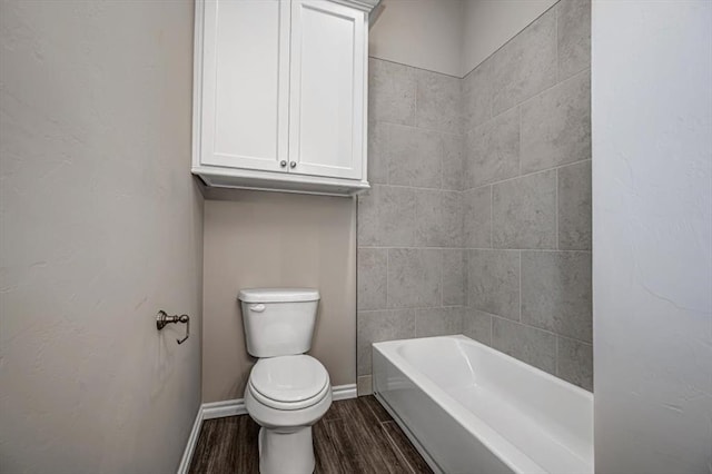 full bath featuring baseboards, wood finished floors, and toilet