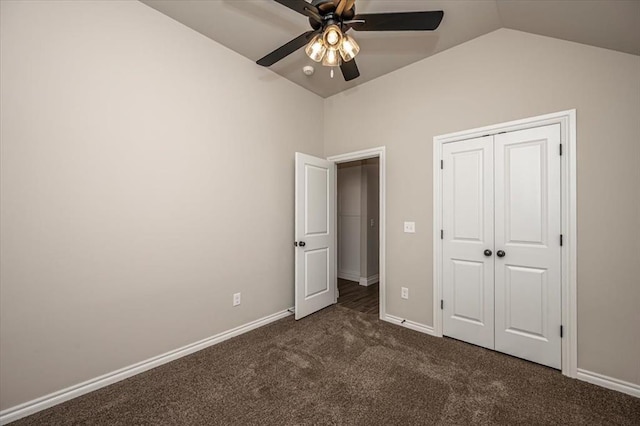 unfurnished bedroom featuring vaulted ceiling, carpet flooring, a closet, baseboards, and ceiling fan