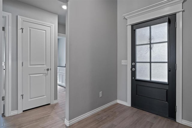 foyer entrance featuring wood finished floors, baseboards, and recessed lighting