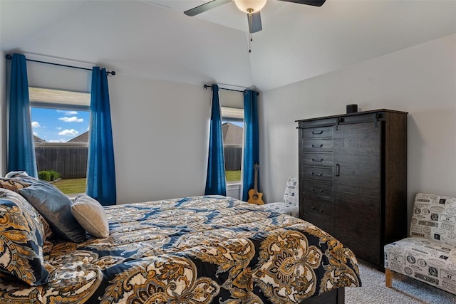 carpeted bedroom with vaulted ceiling and ceiling fan