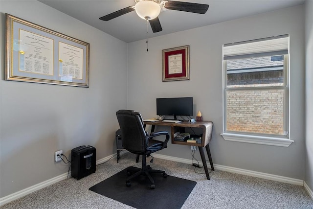 office space with carpet flooring, a ceiling fan, and baseboards