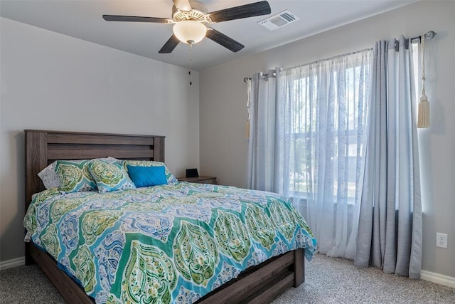 carpeted bedroom with baseboards and ceiling fan