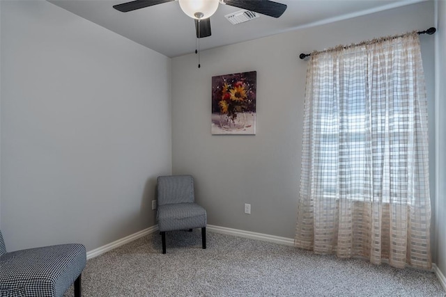 living area featuring ceiling fan, carpet floors, and baseboards