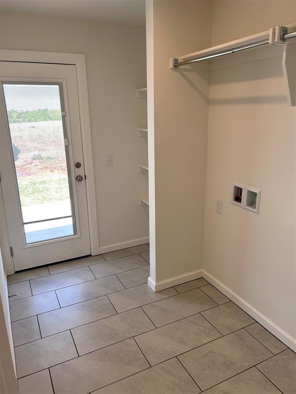 2933 NW 196th Pl, Edmond, OK 73012 - washroom with washer hookup, light tile patterned floors, and baseboards