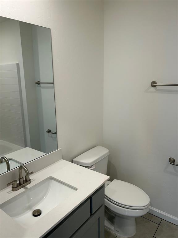 2933 NW 196th Pl, Edmond, OK 73012 - bathroom with tile patterned floors, toilet, and vanity