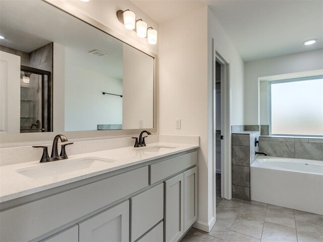 959 SE 16th Ter, Newcastle, OK 73065 - bathroom with a shower stall, a garden tub, tile patterned flooring, double vanity, and recessed lighting