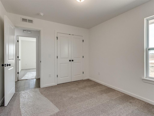 959 SE 16th Ter, Newcastle, OK 73065 - unfurnished bedroom featuring carpet, baseboards, and a closet