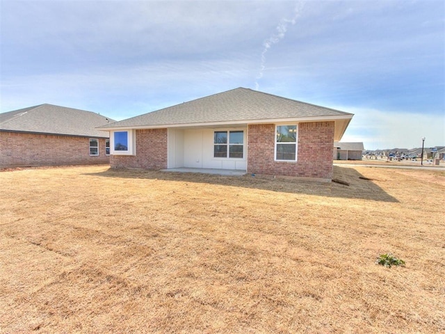 959 SE 16th Ter, Newcastle, OK 73065 - rear view of house with brick siding, a lawn, and a shingled roof