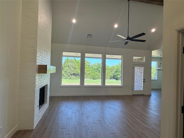 9596 Regado Ct, Guthrie, OK 73044 - unfurnished living room with ceiling fan, high vaulted ceiling, baseboards, dark wood-style floors, and a fireplace