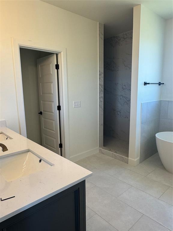 9596 Regado Ct, Guthrie, OK 73044 - full bath featuring a walk in shower, a freestanding bath, vanity, and tile patterned flooring