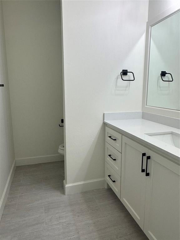 9596 Regado Ct, Guthrie, OK 73044 - bathroom with vanity, baseboards, and toilet