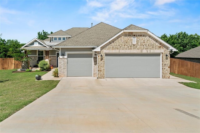 2803 Redwood Ct, Newcastle, OK 73065 - view of front of house featuring a garage, driveway, stone siding, and roof with shingles