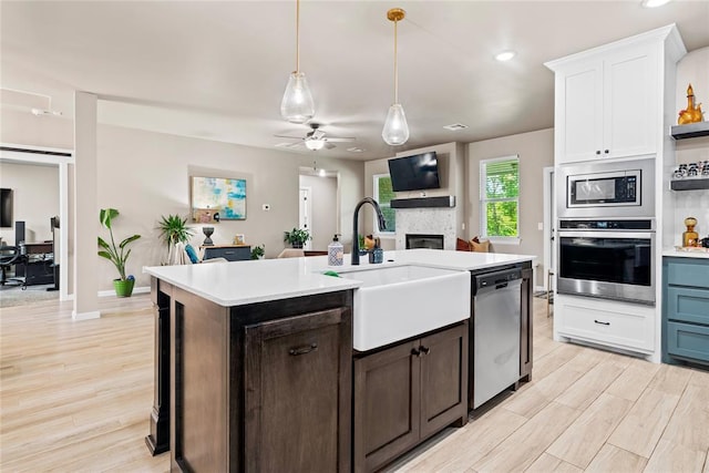 2803 Redwood Ct, Newcastle, OK 73065 - kitchen with stainless steel appliances, a sink, light countertops, ceiling fan, and white cabinetry