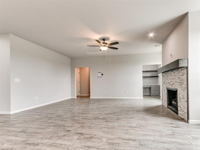 929 SE 16th Ter, Newcastle, OK 73065 - unfurnished living room featuring a ceiling fan, baseboards, a fireplace, and light wood-style flooring