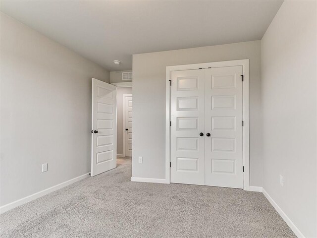 929 SE 16th Ter, Newcastle, OK 73065 - unfurnished bedroom with carpet floors, a closet, and baseboards