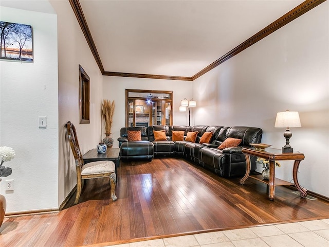 living area with ornamental molding, baseboards, and wood finished floors