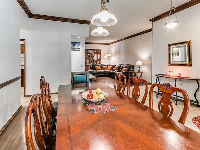 dining room featuring ornamental molding and baseboards