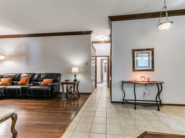 living area with ornamental molding, light tile patterned flooring, and baseboards