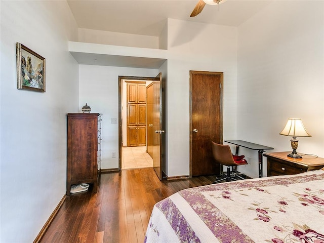 bedroom with hardwood / wood-style flooring and baseboards