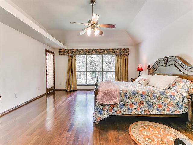 bedroom with hardwood / wood-style floors, a ceiling fan, baseboards, vaulted ceiling, and baseboard heating