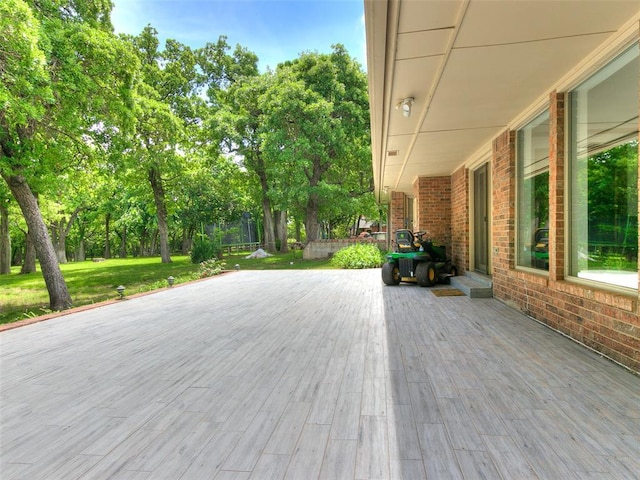 wooden terrace with a yard