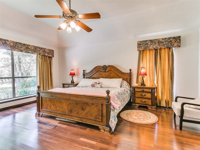13974 S Broadway St, Edmond, OK 73034 - bedroom featuring wood finished floors, vaulted ceiling, a baseboard heating unit, and ceiling fan