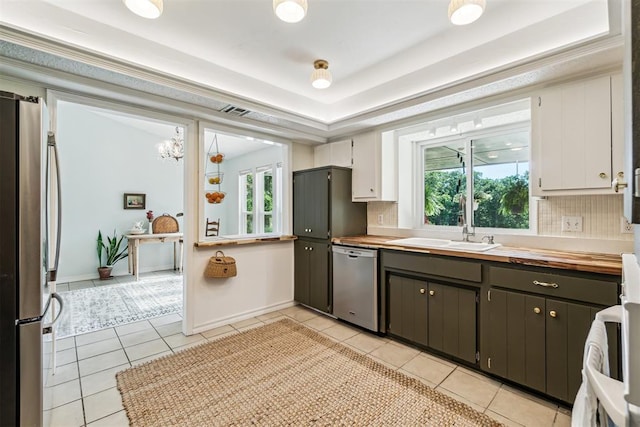 125 Creek Hollow Dr, Choctaw, OK 73020 - kitchen featuring stainless steel appliances, butcher block countertops, backsplash, and healthy amount of natural light