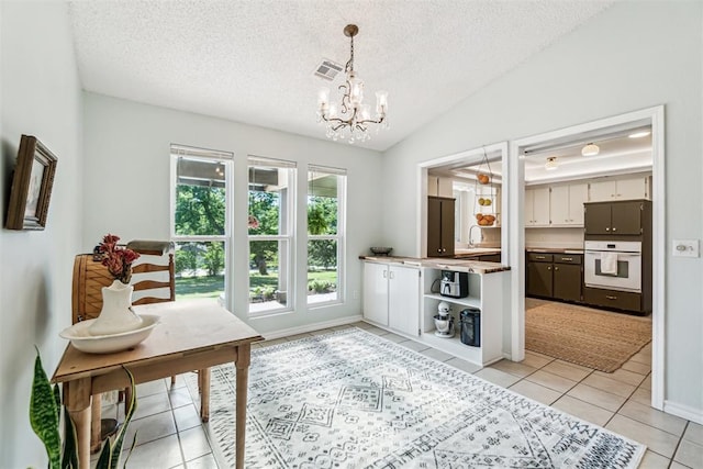 125 Creek Hollow Dr, Choctaw, OK 73020 - dining room with light tile patterned floors, a chandelier, a textured ceiling, vaulted ceiling, and baseboards