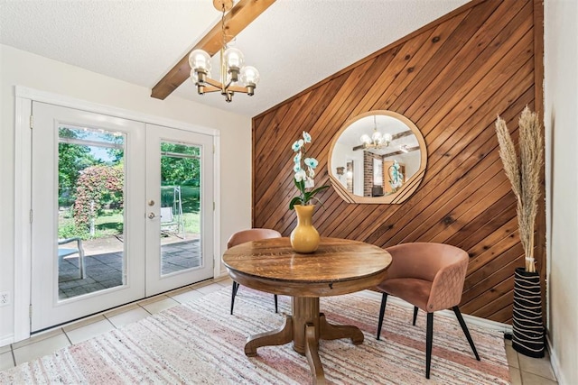 125 Creek Hollow Dr, Choctaw, OK 73020 - dining room with french doors, a chandelier, light tile patterned floors, wood walls, and a textured ceiling