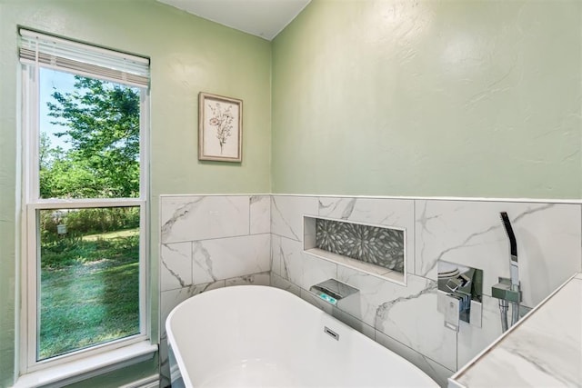 125 Creek Hollow Dr, Choctaw, OK 73020 - bathroom with a freestanding bath and tile walls