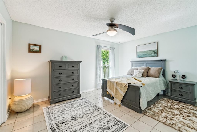 125 Creek Hollow Dr, Choctaw, OK 73020 - bedroom with access to exterior, light tile patterned flooring, ceiling fan, a textured ceiling, and baseboards