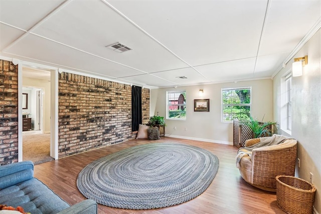 125 Creek Hollow Dr, Choctaw, OK 73020 - sitting room featuring wood finished floors, brick wall, and baseboards