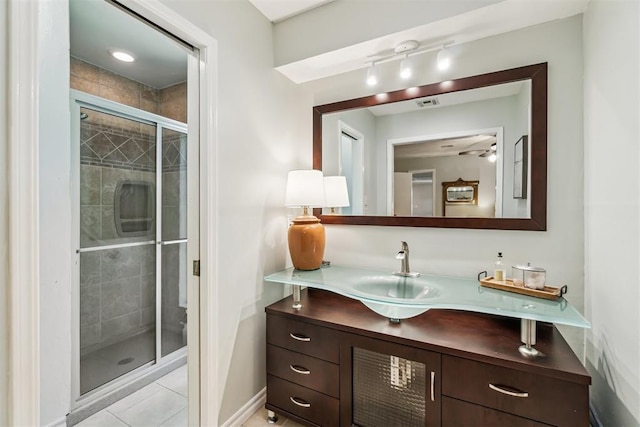 125 Creek Hollow Dr, Choctaw, OK 73020 - full bathroom featuring a stall shower, vanity, tile patterned flooring, a ceiling fan, and baseboards