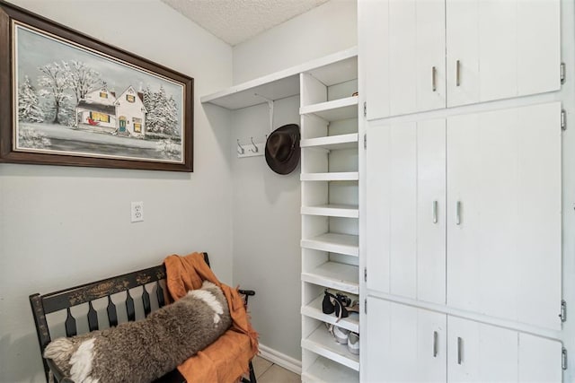 125 Creek Hollow Dr, Choctaw, OK 73020 - bedroom with a textured ceiling, baseboards, and tile patterned floors
