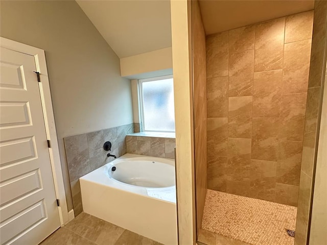 1216 SW 139th St, Oklahoma City, OK 73170 - full bathroom with a bath, vaulted ceiling, tile patterned floors, and tiled shower