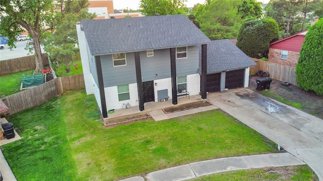 view of front facade featuring roof with shingles, an attached garage, concrete driveway, and a porch