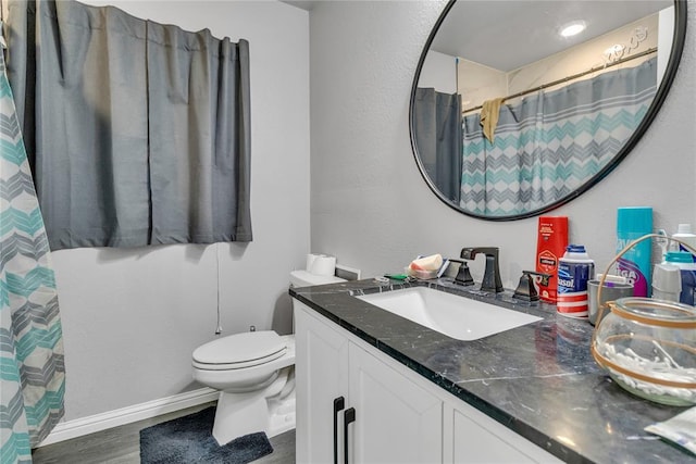 full bathroom featuring toilet, vanity, wood finished floors, and curtained shower