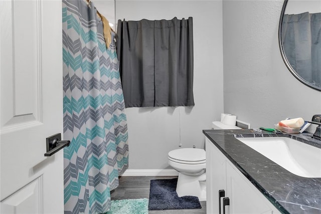 full bath with toilet, wood finished floors, vanity, and a shower with shower curtain