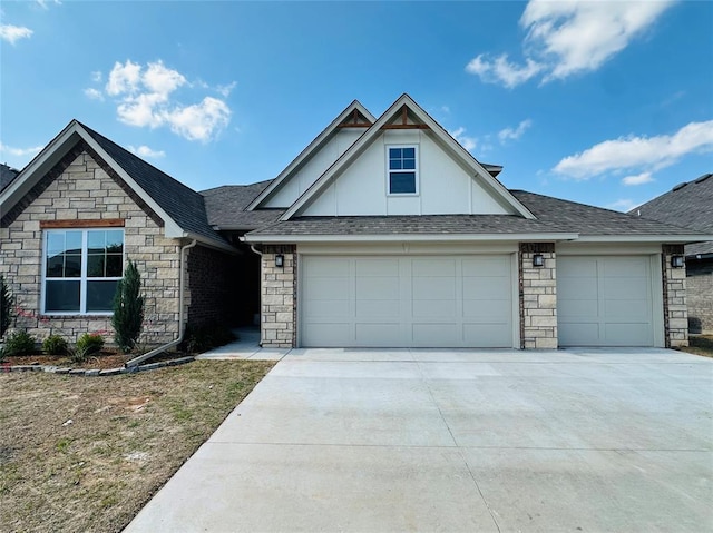 917 SW 141st St, Oklahoma City, OK 73170 - view of front of home featuring stone siding, a garage, concrete driveway, and roof with shingles