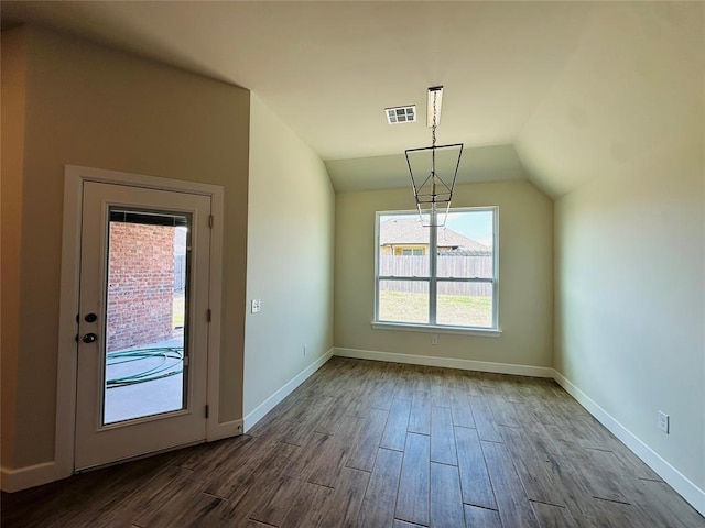 917 SW 141st St, Oklahoma City, OK 73170 - unfurnished dining area with dark wood finished floors, baseboards, and lofted ceiling
