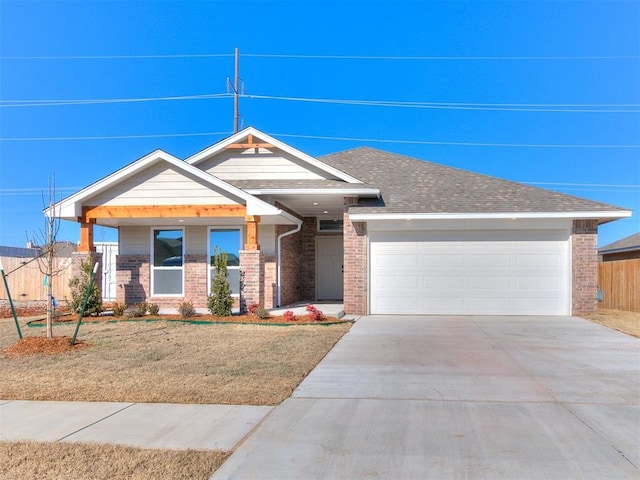 8617 NW 77th St, Oklahoma City, OK 73132 - view of front of property featuring brick siding, an attached garage, driveway, and a front yard