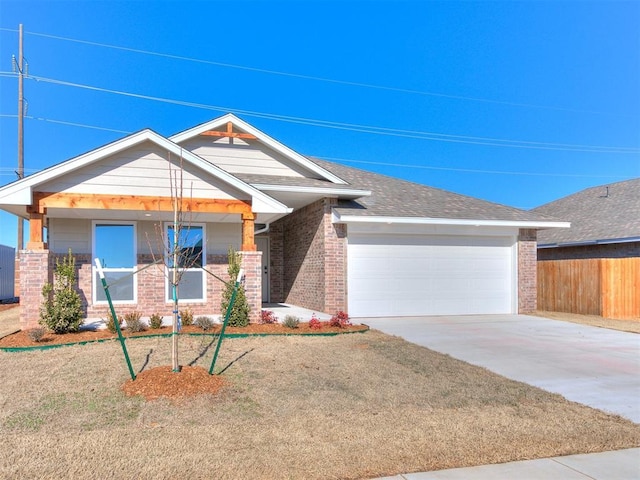 8617 NW 77th St, Oklahoma City, OK 73132 - view of front of home featuring brick siding, a garage, and driveway