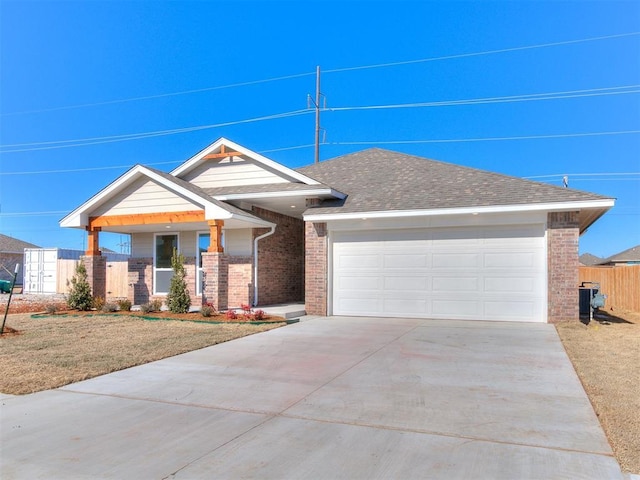 8617 NW 77th St, Oklahoma City, OK 73132 - view of front of home featuring brick siding, concrete driveway, and an attached garage