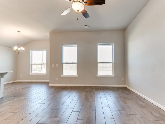 8617 NW 77th St, Oklahoma City, OK 73132 - spare room with a chandelier, ceiling fan, plenty of natural light, lofted ceiling, and wood finished floors